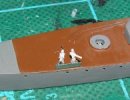 [Shield, ammo boxes and plastic 25mm single guns on an unfinished Shimakaze model]