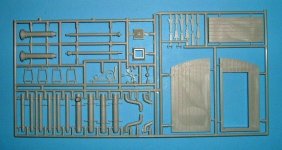 [the injection molded parts include doors, window frames, hinges, gutters and a lamppost.]